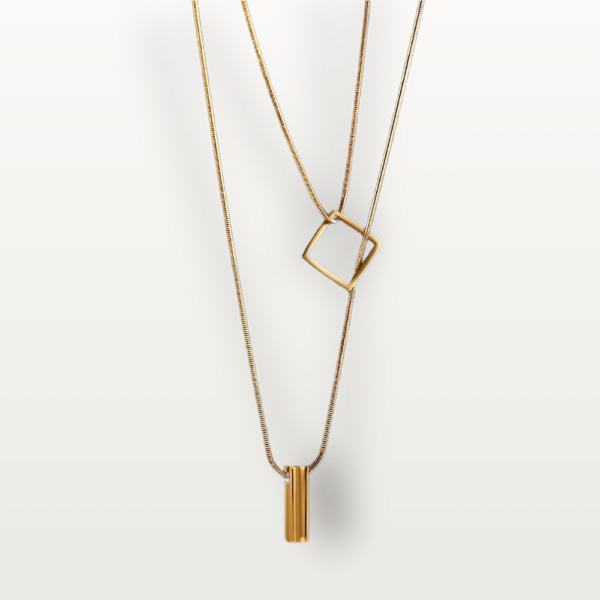 Close-up of Chic Layered Geometric Necklace with a gold geometric pendant.